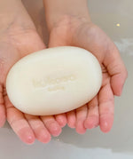 A close up of a child holding the Kokoso Organic Baby Soap available at Babipur. 