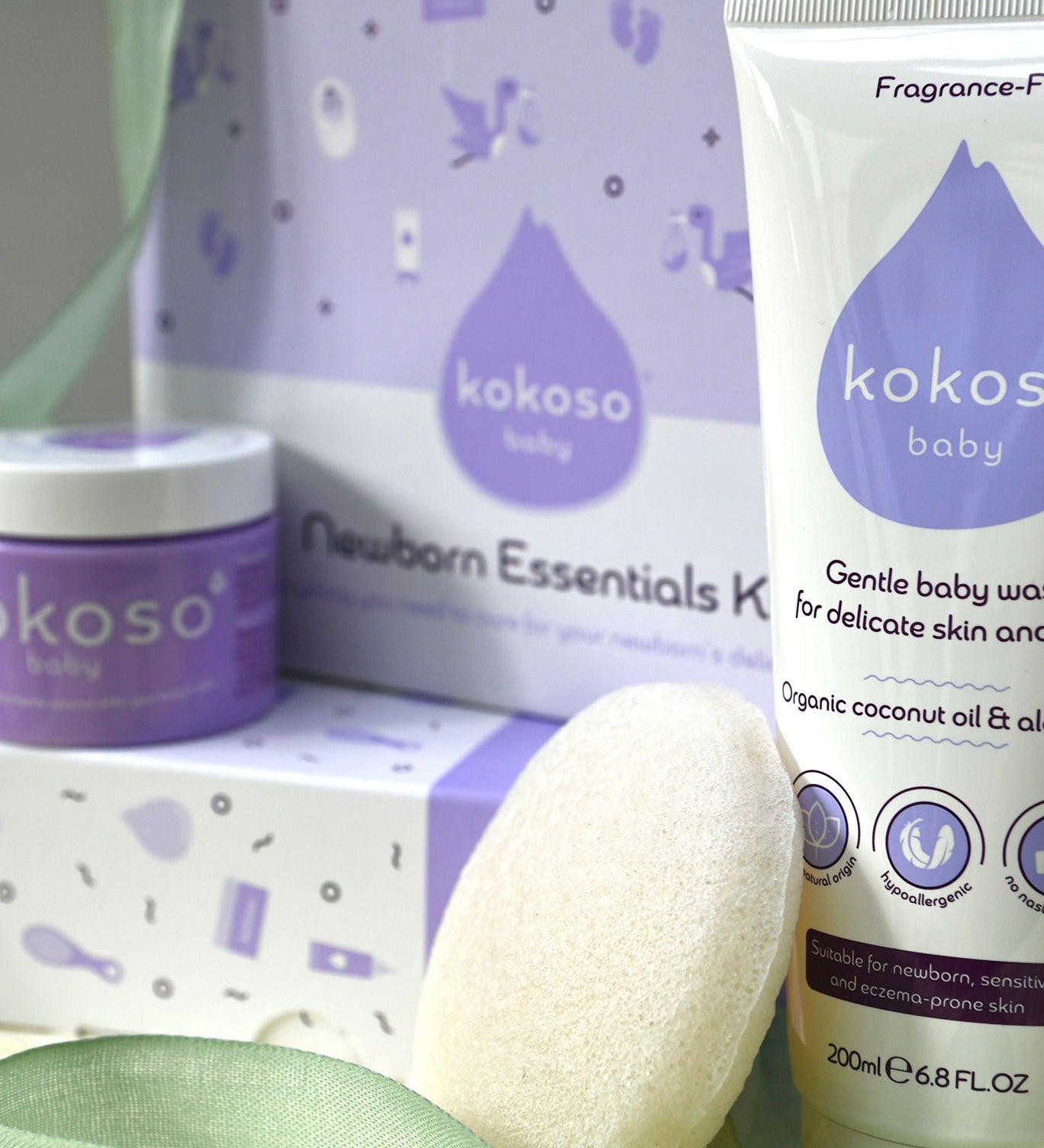 A close up of the contents included with the Kokoso newborn essentials kit showing the Kokoso Organic Coconut Oil, the Kokoso Gentle Hair & Body Wash and a Kokoso 100% Natural Konjac Baby Bath Sponge