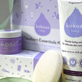 A close up of the contents included with the Kokoso newborn essentials kit showing the Kokoso Organic Coconut Oil, the Kokoso Gentle Hair & Body Wash and a Kokoso 100% Natural Konjac Baby Bath Sponge