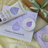 A top down image of the contents on included with the Kokoso newborn essentials kit showing the Kokoso Organic Coconut Oil, the Kokoso Gentle Hair & Body Wash and a Kokoso 100% Natural Konjac Baby Bath Sponge. Newborn essentials kit available at Babipur.