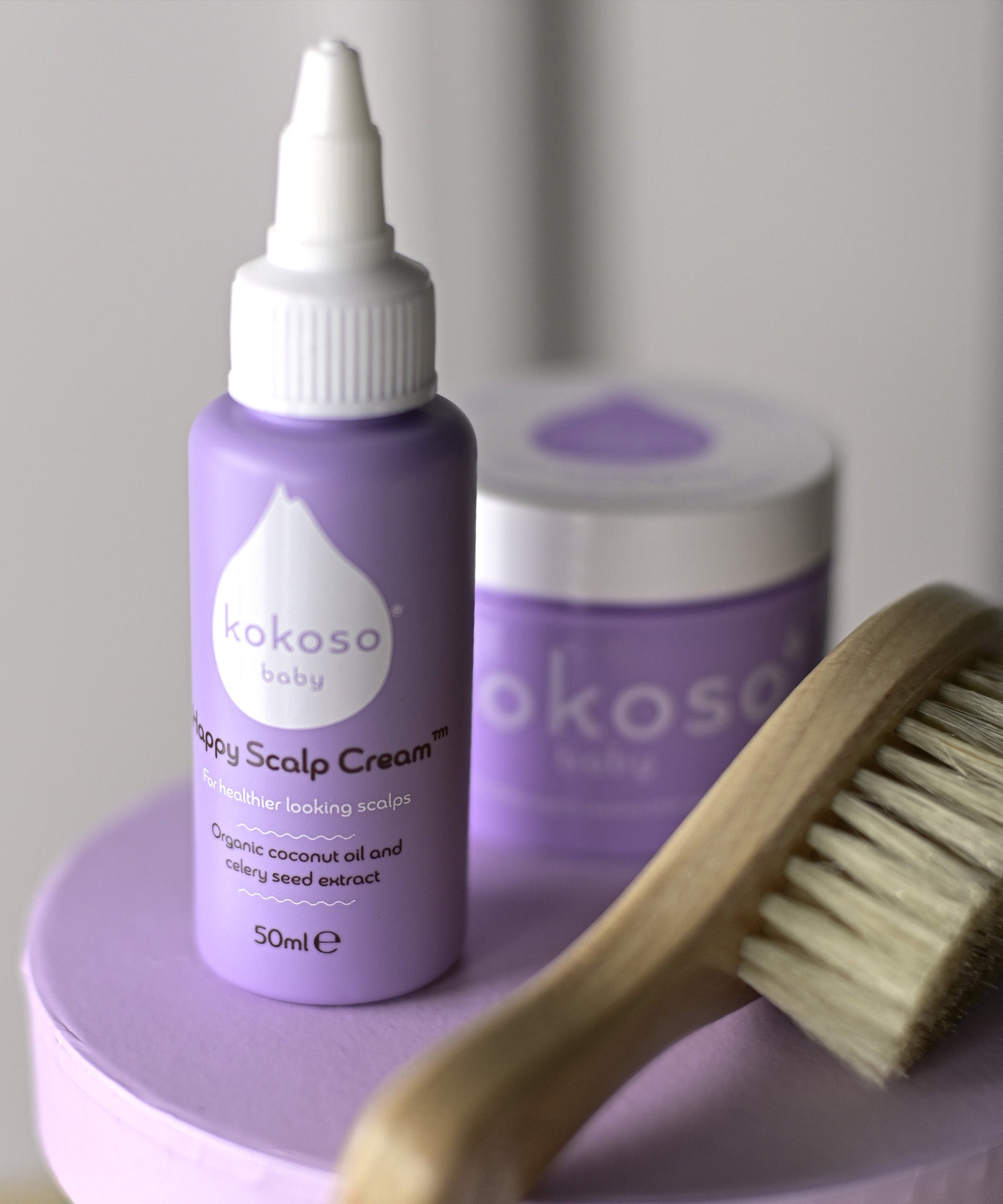 A close up of the products included with the sensitive gift set showing the scalp cream, natural baby brush and and organic coconut oil available at Babipur.
