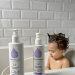  and Hair & Body Wash bottles next to each other on a white fluffy rug