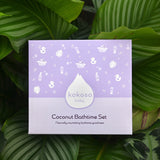 with 2 green ribbons and scissors ready for wrapping. A Kokoso Coconut Bathtime Organic Baby Gift Set box with contents laid out on the paper. Contents are Kokoso Natural Baby Konjac Sponge
