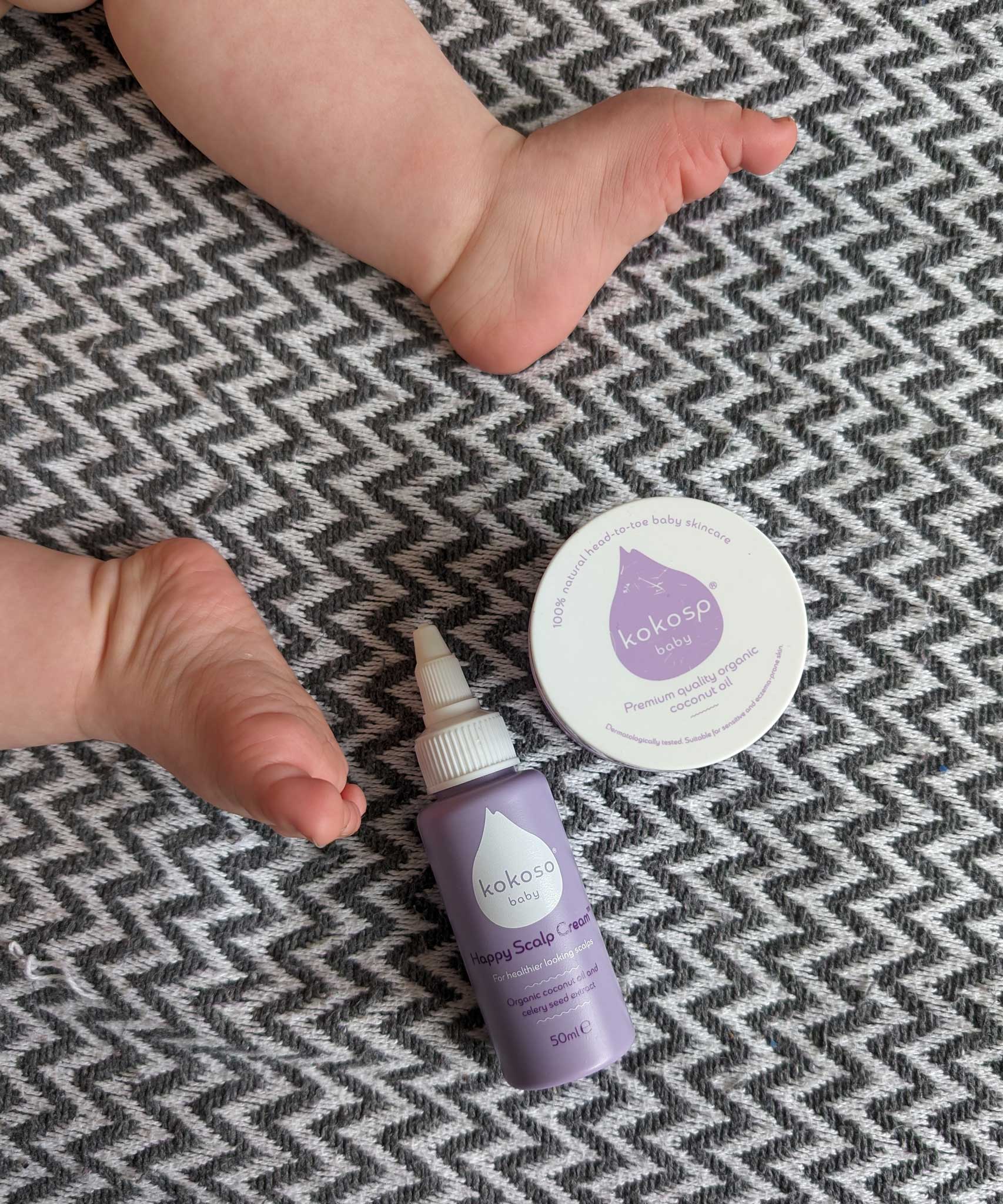 Kokoso Happy Scalp Cream in a 50ml container next to a small tub of Kokoso organic coconut oil. The Kokoso baby care range is available at Babipur.