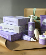 A range of Kokoso gift sets on a table ready to be wrapped. Showing the newborn essentials kit, sensitive scalp set and coconut bathtime set all available at Babipur.