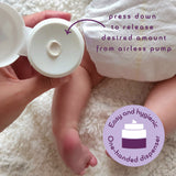 An adult hand holding the  tube of Kokoso organic coconut oil Happy Nappy Cream above a baby and showing the one handed dispenser feature.  Kokoso's range of organic  coconut oil baby care is available at Babipur. 