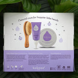 The back of the The Sensitive Scalp Set box with a tropical leaves in the background, includes Scalp Cream, Natural Baby Brush and and organic Coconut oil available at Babipur.