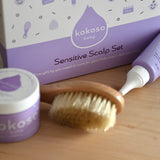 A close up of the products from the sensitive gift set showing the scalp cream, natural baby brush and and organic coconut oil available at Babipur.