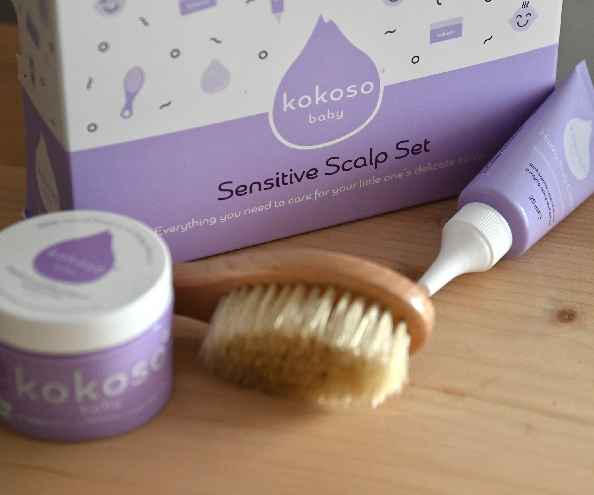 A close up of the products from the sensitive gift set showing the scalp cream, natural baby brush and and organic coconut oil available at Babipur.