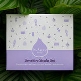 The Sensitive Scalp Set box with a tropical leaves in the background, includes Scalp Cream, Natural Baby Brush and and organic Coconut oil available at Babipur.