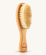 The Kokoso Natural Baby Hairbrush available at Babipur. Features a wooden handle and soft natural bristles