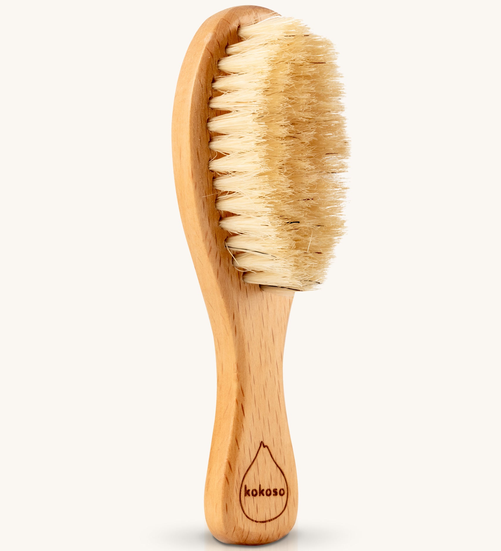 The Kokoso Natural Baby Hairbrush available at Babipur. Features a wooden handle and soft natural bristles