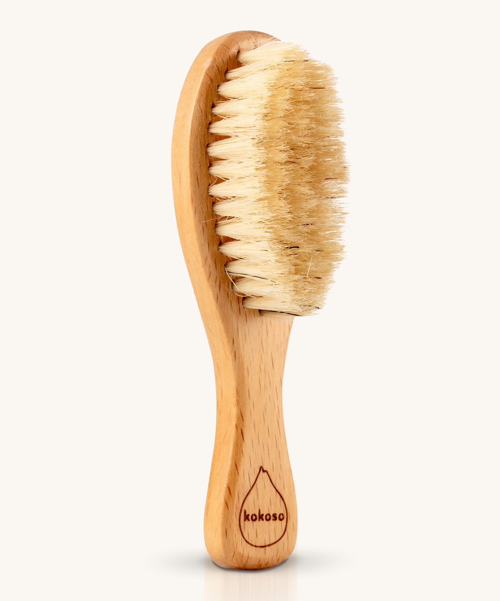 The Kokoso Natural Baby Hairbrush available at Babipur. Features a wooden handle and soft natural bristles
