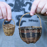 A child holding the small and large Kraul baskets next to each other. Perfect for small world play or as additional parts fro the Kraul kits. 