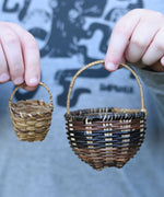 A child holding the small and large Kraul baskets next to each other. Perfect for small world play or as additional parts fro the Kraul kits. 