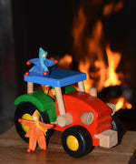 Kraul felt passenger pose-able dolls placed in the cab and on the roof the of the Bajo wooden tractor toy. These pose-able dolls are perfect to fit inside smaller toy vehicles and for use with the Kraul cable cars.