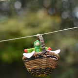 A green felt Kraul Little Passenger Doll in a Kraul basket. These pose-able dolls are perfect to fit inside smaller toy vehicles and for use with the Kraul cable cars.