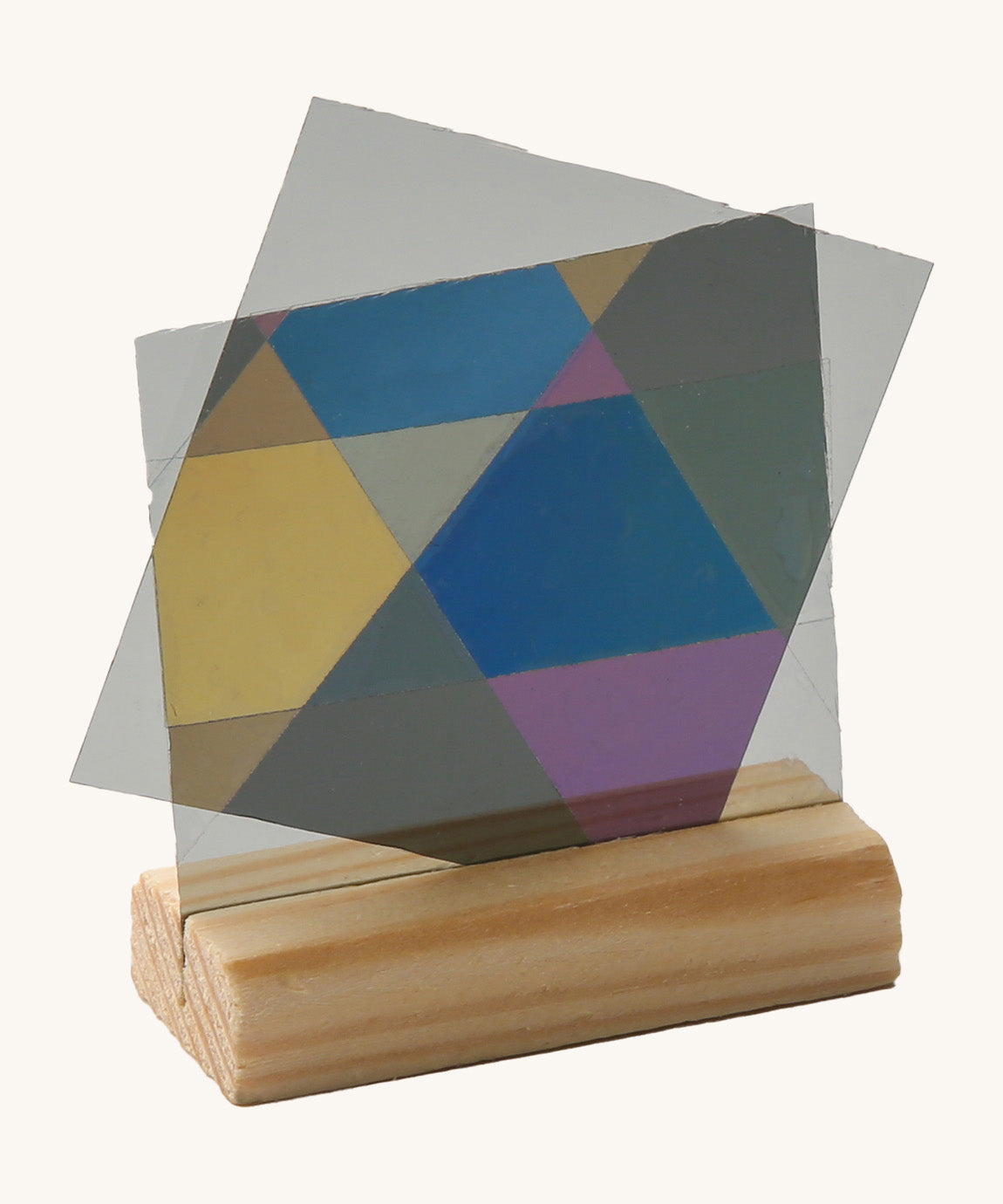 Close up view of the mirrors on a wooden stand from the Kraul lights and colour kit creating different coloured prism shapes 