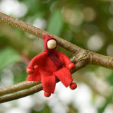 A red felt Kraul Little Passenger Doll. These pose-able dolls are perfect to fit inside smaller toy vehicles and for use with the Kraul cable cars.