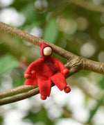 A red felt Kraul Little Passenger Doll. These pose-able dolls are perfect to fit inside smaller toy vehicles and for use with the Kraul cable cars.