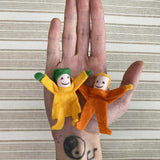 Kraul Tumbling Gnome Tumbelina and pandy on an adult's hand. 