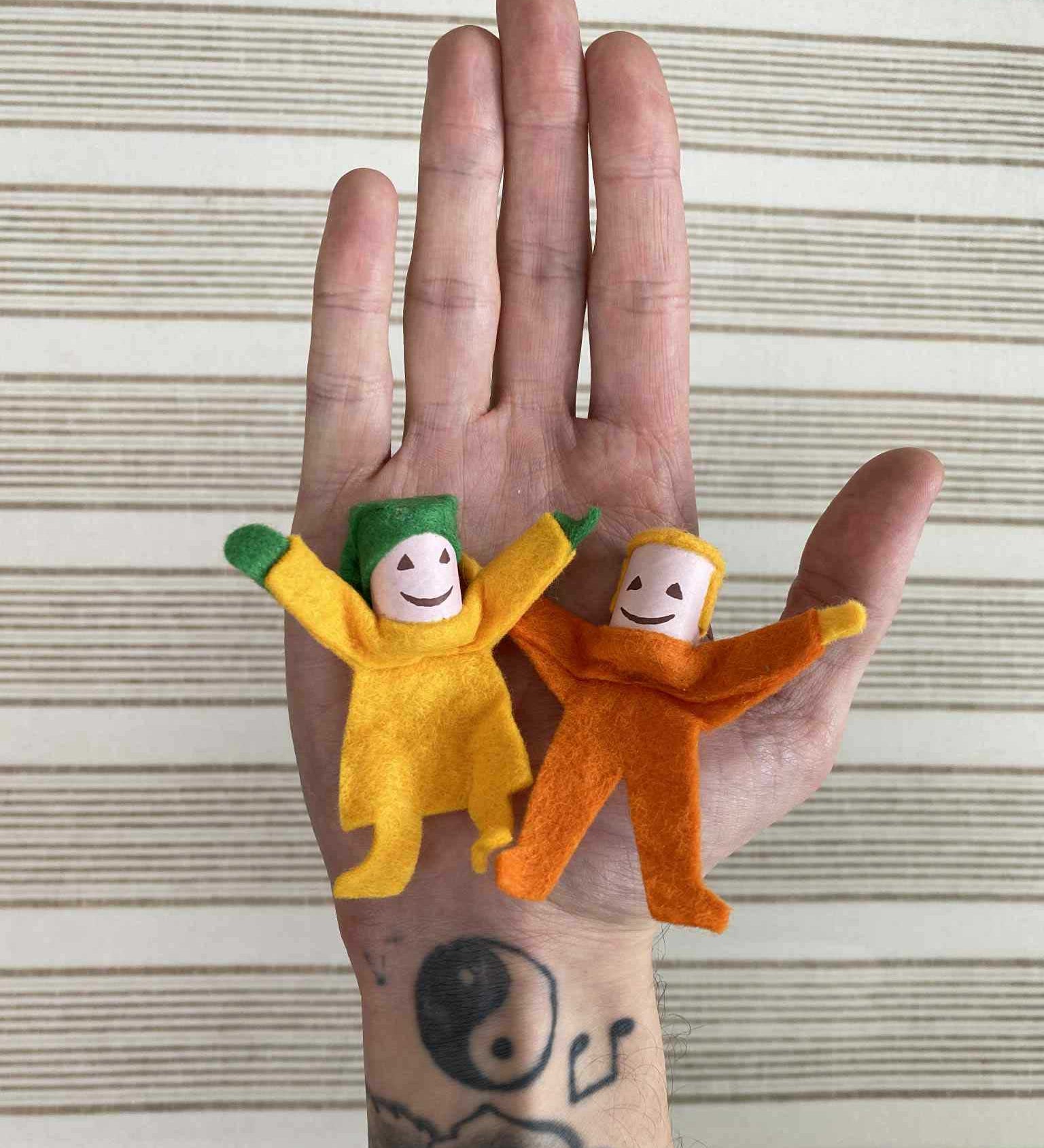 Kraul Tumbling Gnome Tumbelina and pandy on an adult's hand. 