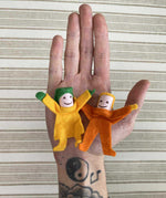 Kraul Tumbling Gnome Tumbelina and pandy on an adult's hand. 