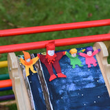 4 Kraul tumbling gnomes placed on a TriClimb Miri slide ready to be tumbled down. These felt gnome dolls come in various colours and sizes.
