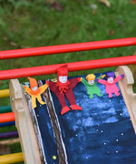 4 Kraul tumbling gnomes placed on a TriClimb Miri slide ready to be tumbled down. These felt gnome dolls come in various colours and sizes.