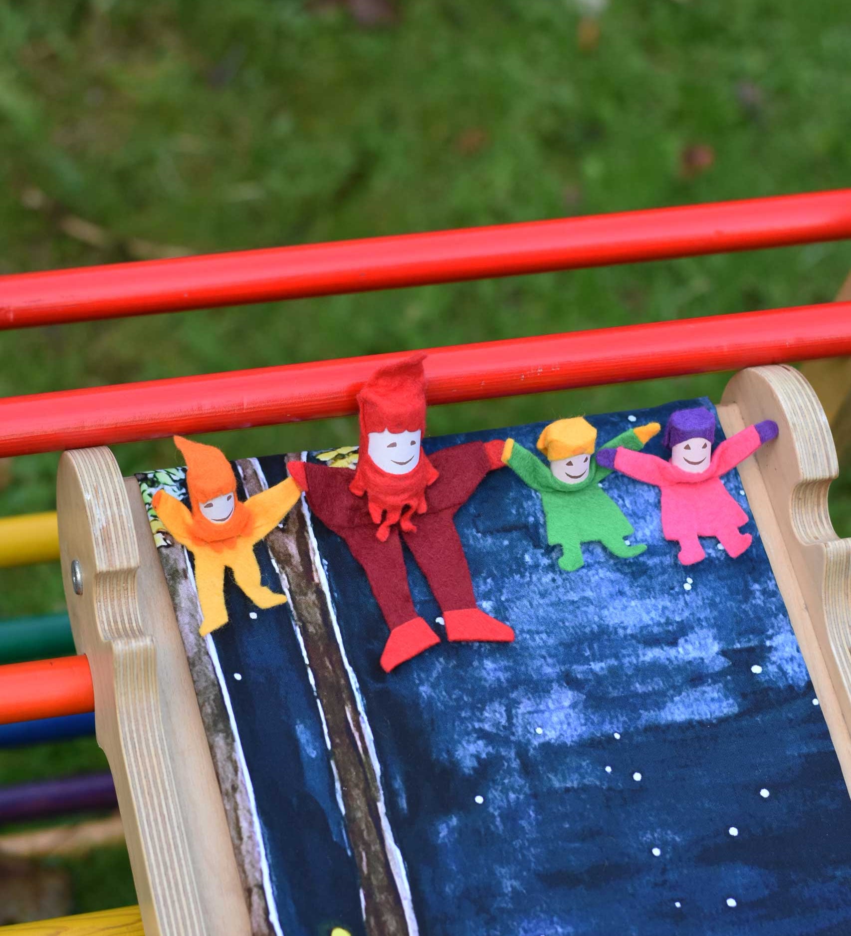 4 Kraul tumbling gnomes placed on a TriClimb Miri slide ready to be tumbled down. These felt gnome dolls come in various colours and sizes.