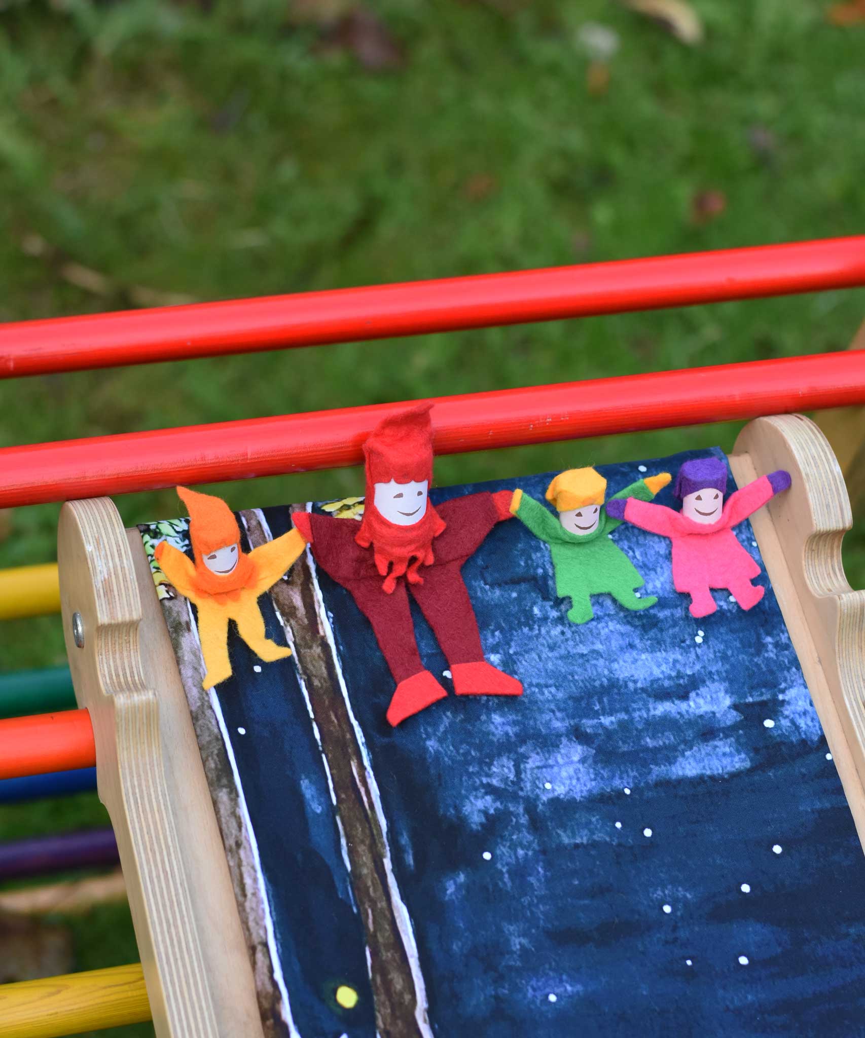 4 Kraul tumbling gnomes placed on a TriClimb Miri slide ready to be tumbled down. These felt gnome dolls come in various colours and sizes.
