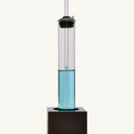 Front view of the Kraul weather kit showing the glass tube with blue liquid on a black wooden stand