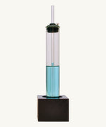 Front view of the Kraul weather kit showing the glass tube with blue liquid on a black wooden stand