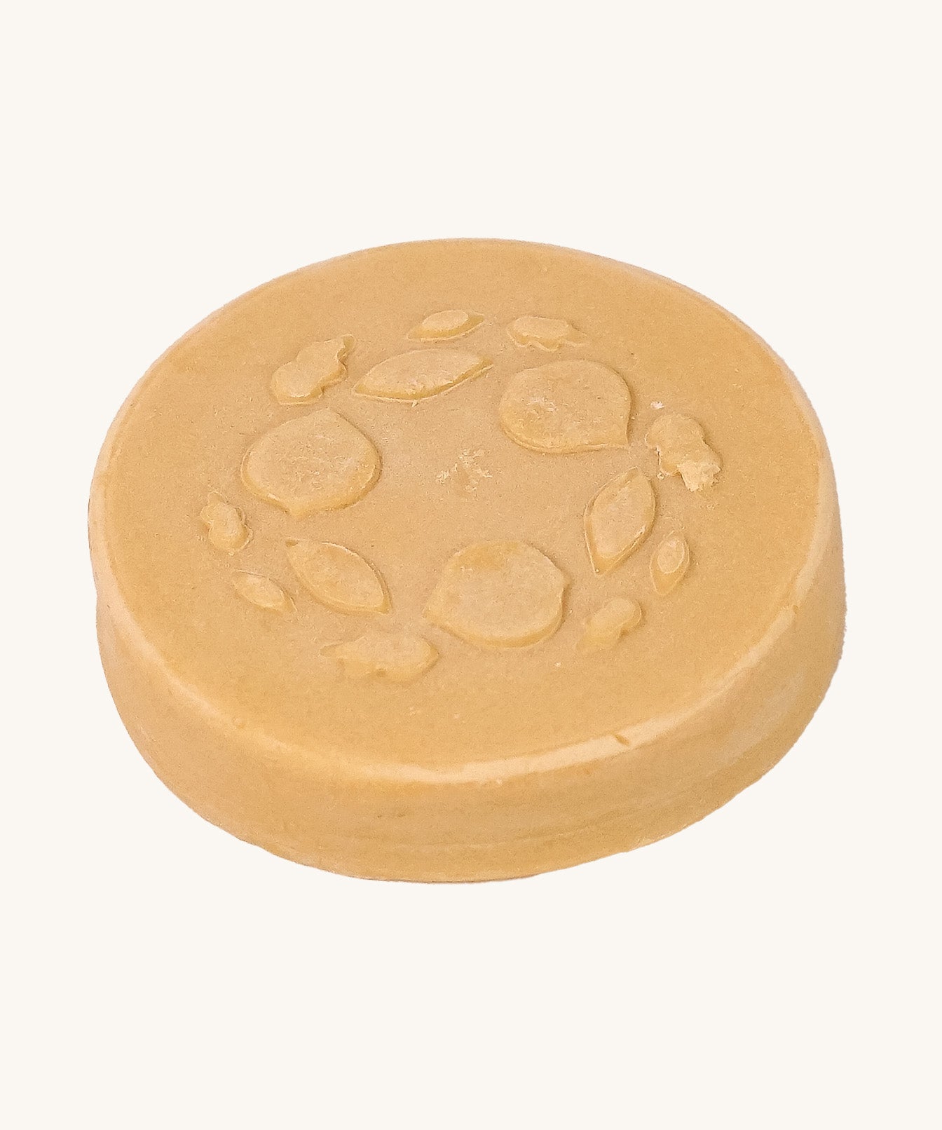 Close-up of the Lamazuna Keratin Repair Solid Shampoo Bar, a round vegan shampoo bar enriched with plant-based keratin.