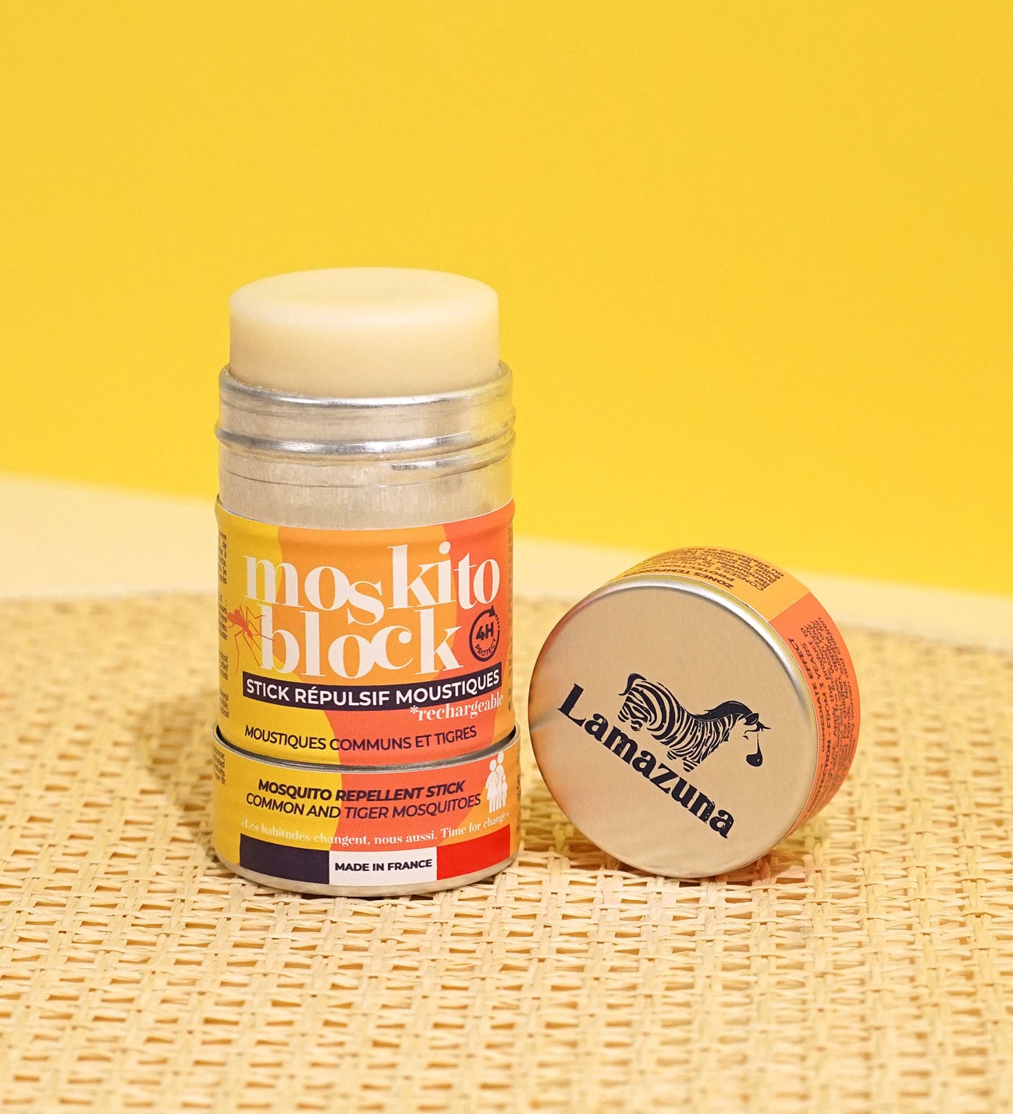 Lamazuna Moskito Block refillable natural mosquito repellent stick displayed with its aluminium lid on a woven surface, highlighting the citronella formula for common and tiger mosquitoes
