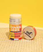 Lamazuna Moskito Block refillable natural mosquito repellent stick displayed with its aluminium lid on a woven surface, highlighting the citronella formula for common and tiger mosquitoes