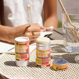 Lamazuna Moskito Block natural mosquito repellent stick shown on an outdoor table, with the refillable aluminium tube open and citronella solid stick visible beside its cardboard packaging