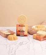 Lamazuna Keratin Repair solid shampoo bar and Keratin Shine conditioner bar arranged with their packaging on a marble bathroom surface.
