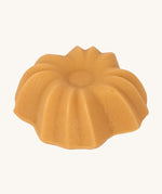 Lamazuna Keratin Shine solid conditioner bar close-up showing its fluted flower-shaped design.
