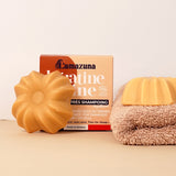 Lamazuna Keratin Shine conditioner bar positioned in front of its box packaging on a soft neutral background