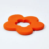 side view of natural rubber orange flower shaped teething toy by Lanco pictured on a plain white background