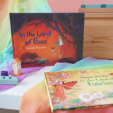 Land of Elves children's hardback book by Daniela Drescher on a shelf next to another series book Land of the Fairies.