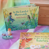 Land of Mermaids children's hardback book by Daniela Drescher on a shelf next to another series book Land of the Fairies.