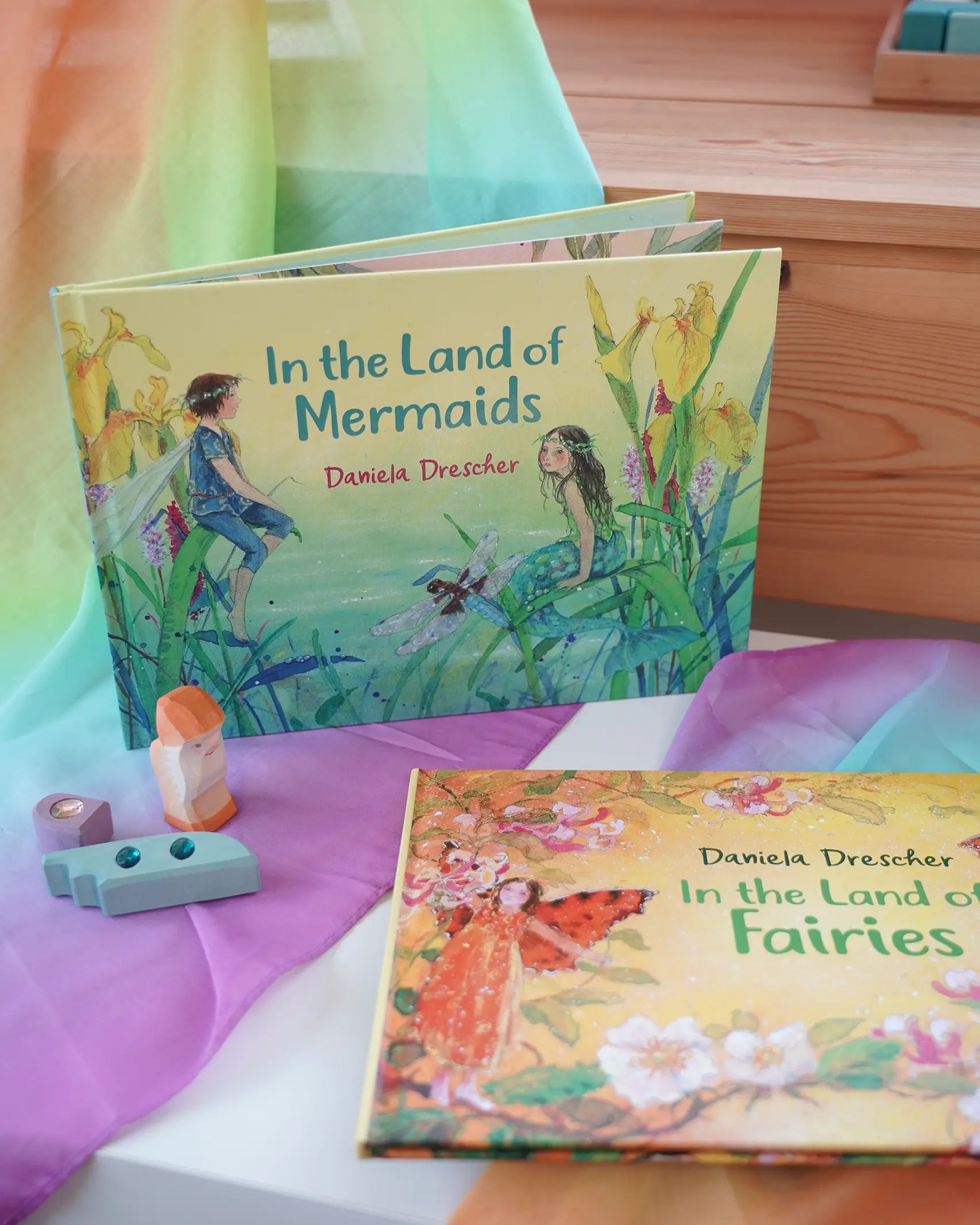 Land of Mermaids children's hardback book by Daniela Drescher on a shelf next to another series book Land of the Fairies.