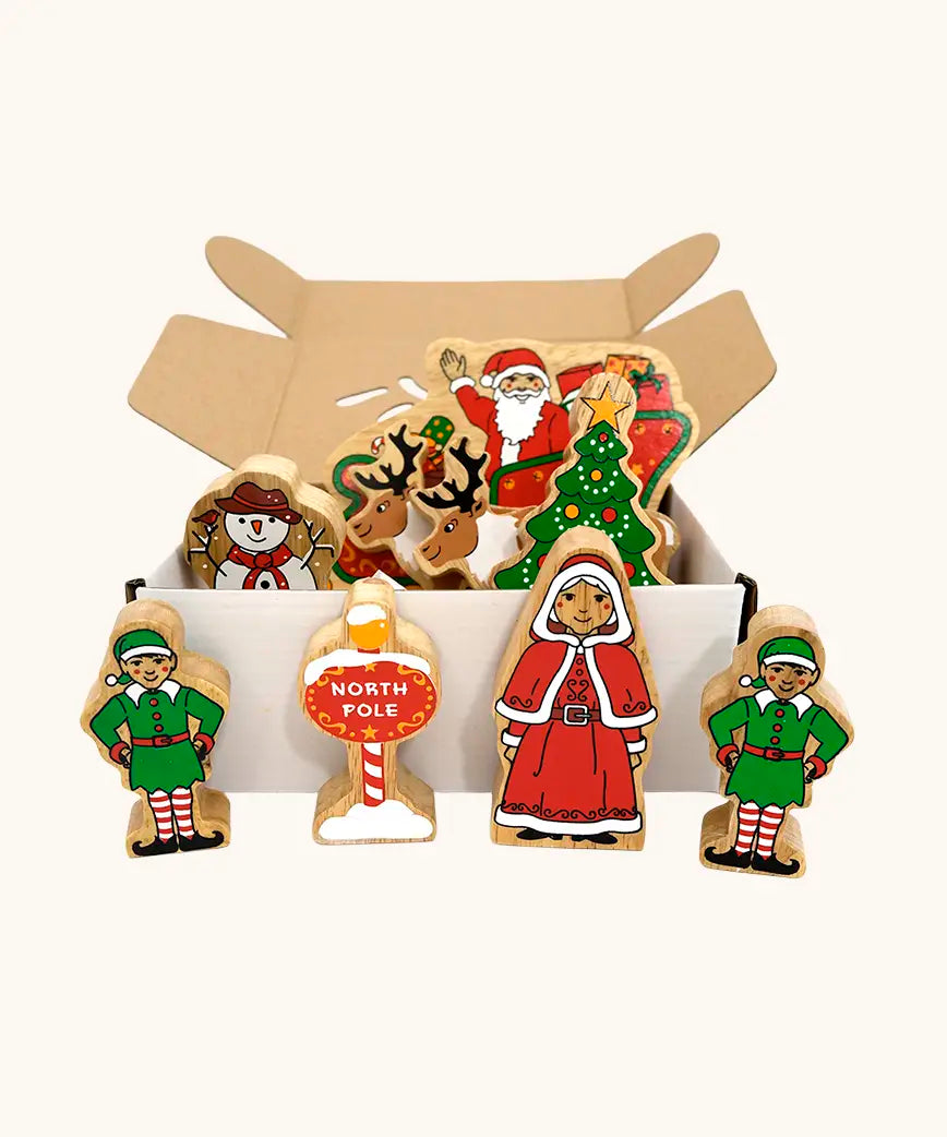 Lanka Kade wooden Christmas play set. 9 toy figures including Santa in his sleigh, Mrs Clause, Christmas Tree, Snowman, North Pole Sign, 2 Elves and 2 Reindeer in a cardboard box.