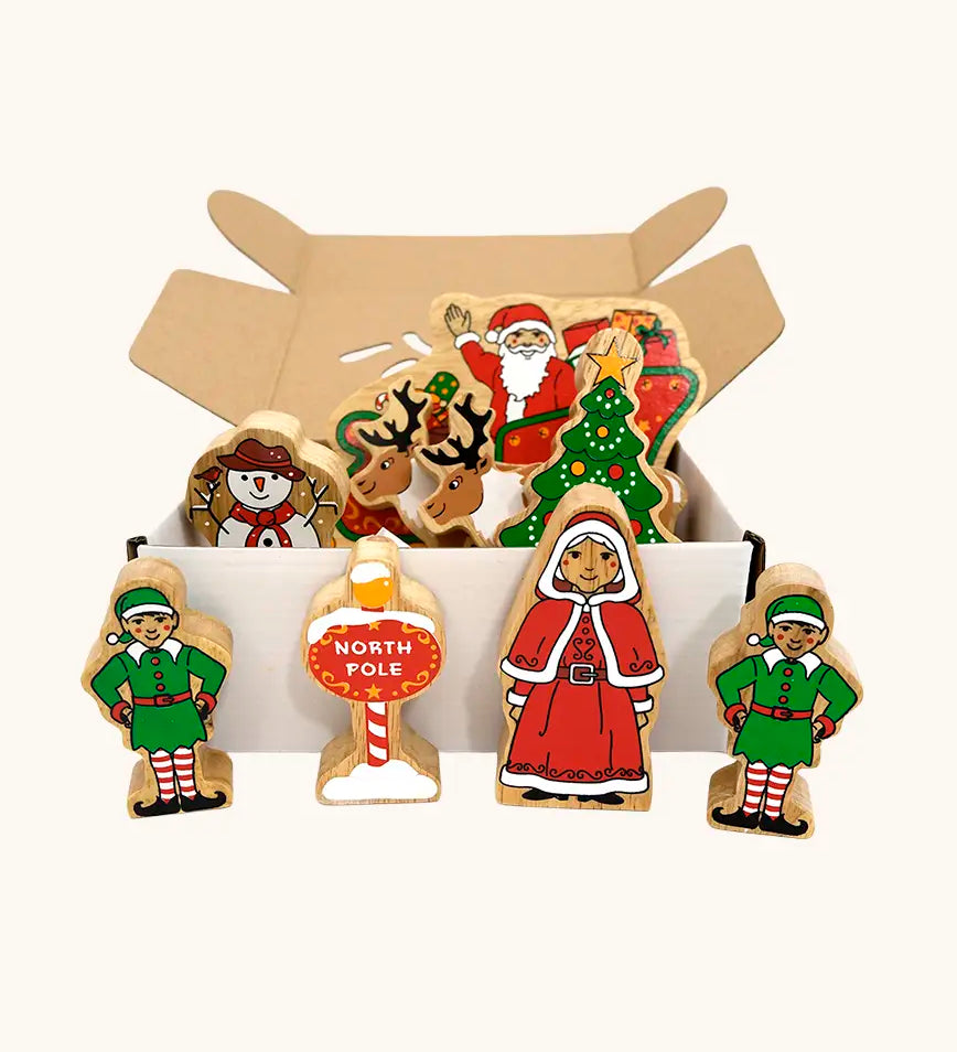 Lanka Kade wooden Christmas play set. 9 toy figures including Santa in his sleigh, Mrs Clause, Christmas Tree, Snowman, North Pole Sign, 2 Elves and 2 Reindeer in a cardboard box.