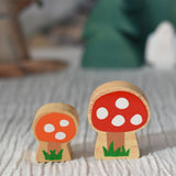 Lanka Kade orange and red spotted toadstool placed on a striped tablecloth. 