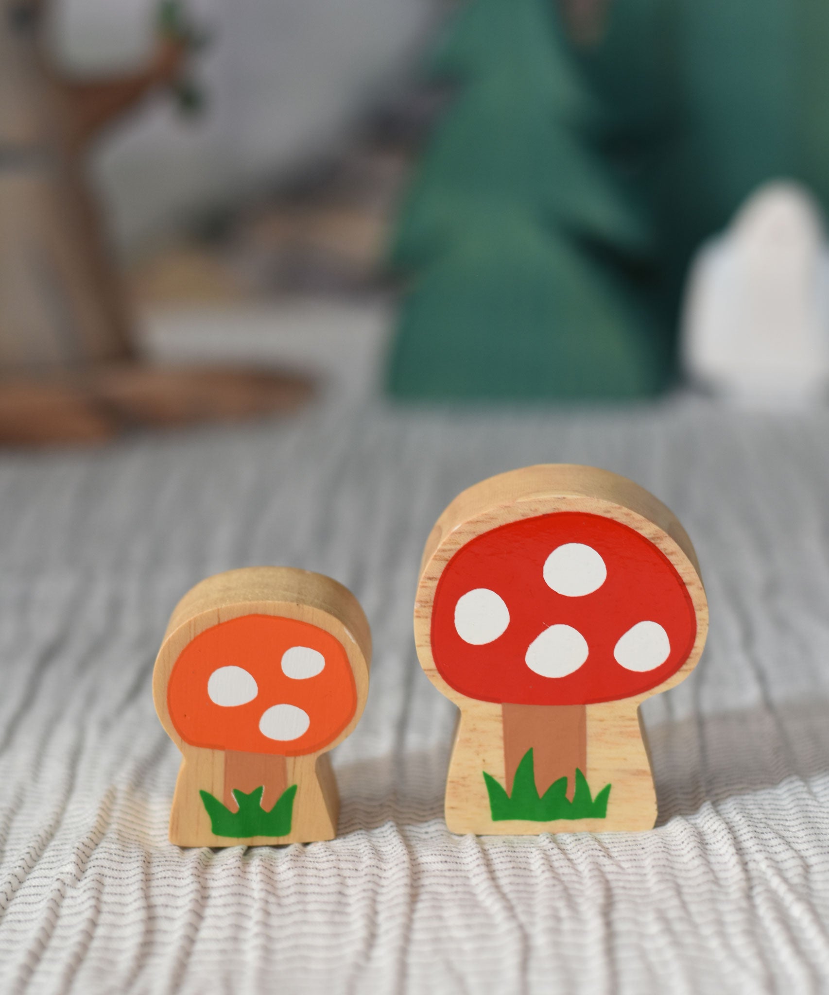 Lanka Kade orange and red spotted toadstool placed on a striped tablecloth. 
