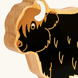 Close up of the painted facial features on the Lanka Kade black highland cow wooden toy figure. 