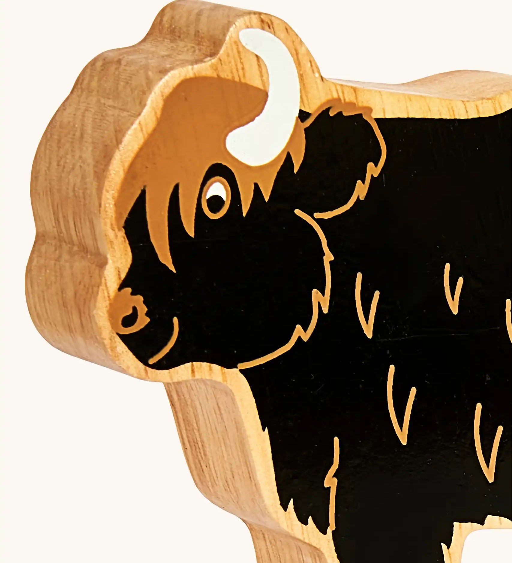 Close up of the painted facial features on the Lanka Kade black highland cow wooden toy figure. 